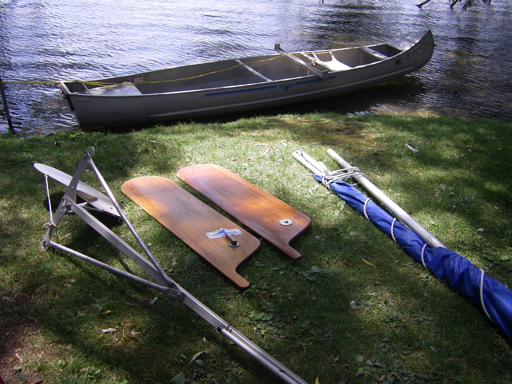 A Grumman Square Stern Sailing Canoe. From left: rudder, leeboards, sail and mast.