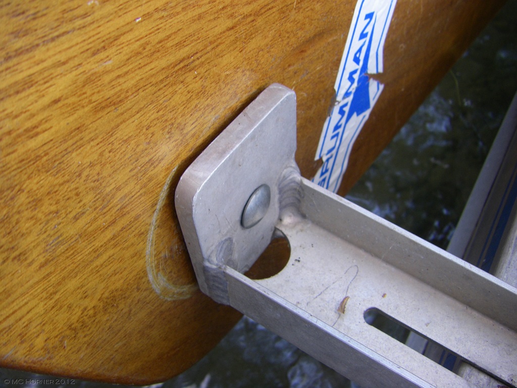 Bolt, bracket,washer, lee board, washer, clamp handle. Do this in shallow water!
