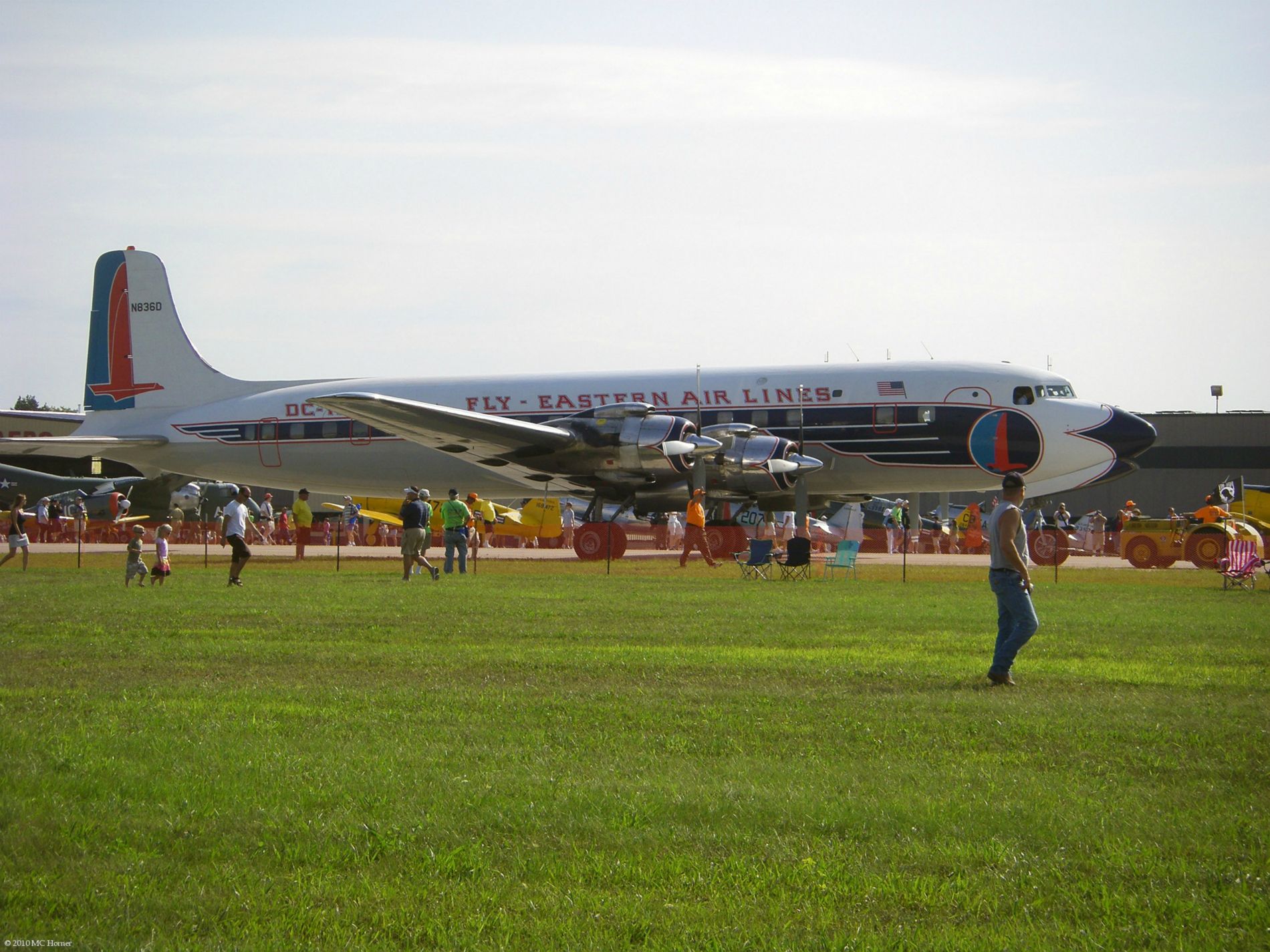 Four-Prop Airliner being taxied towards takeoff.