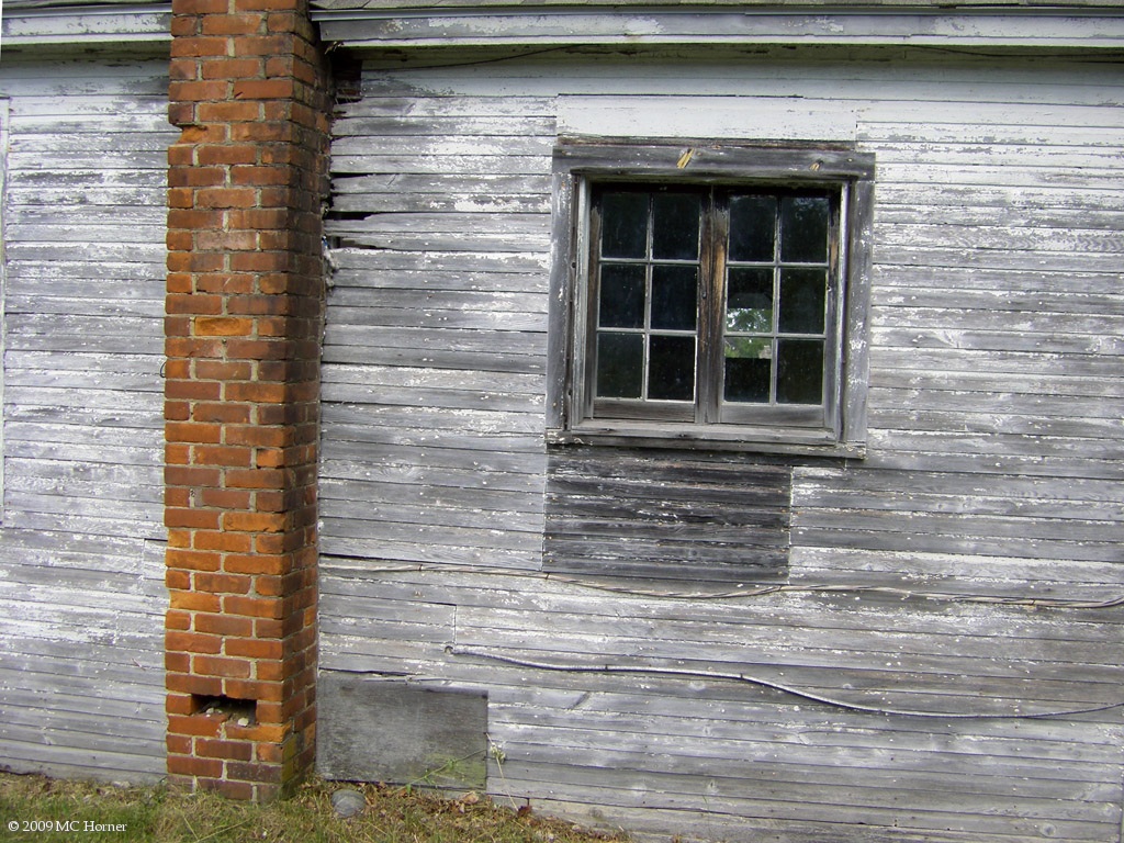 Old window in an even older hole.