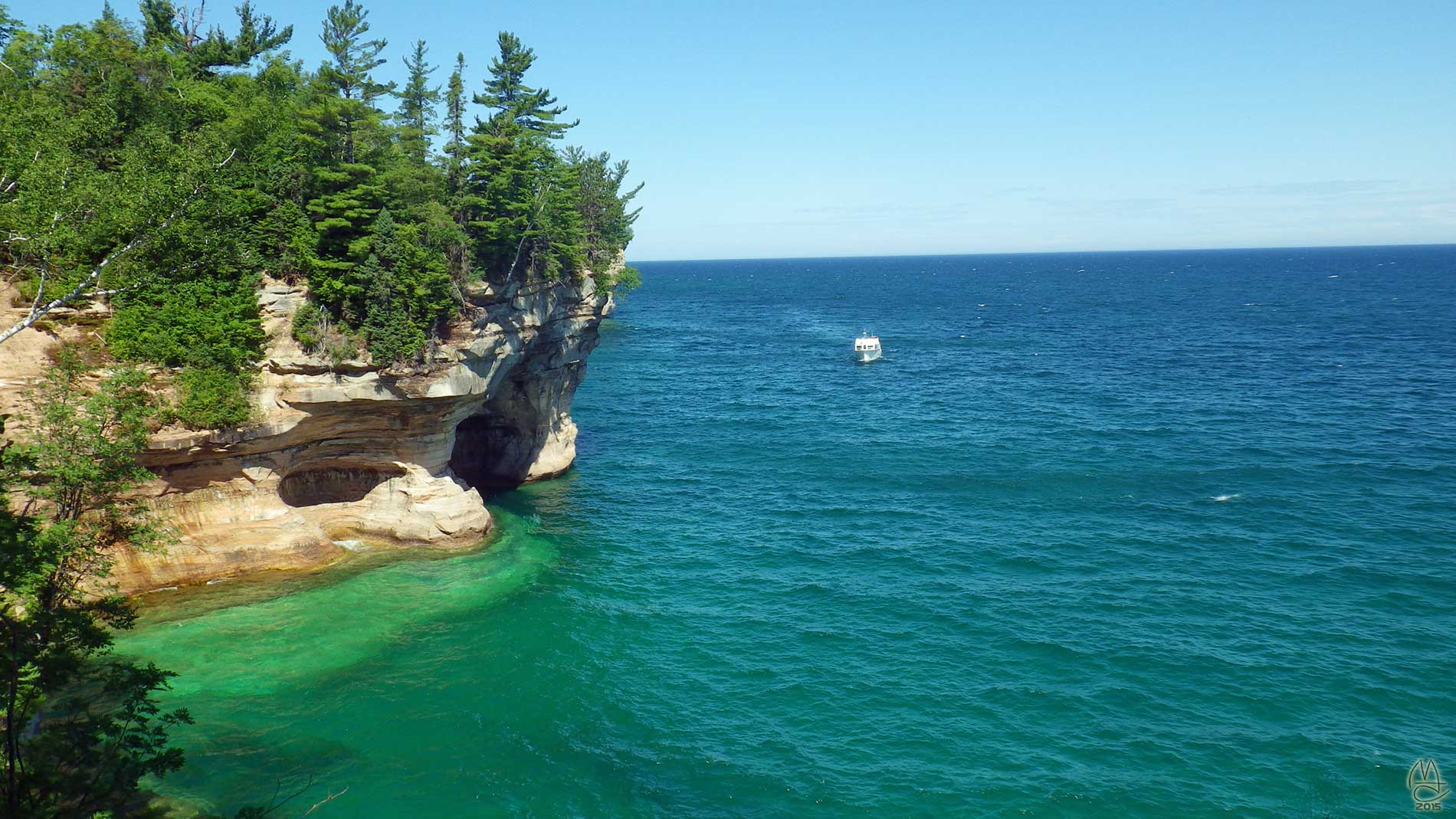 First tour boat of the day rounds the point.